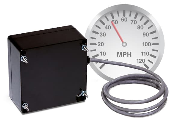 Photo of the Wanco speed-radar assembly with an illustration of a speedometer in the background